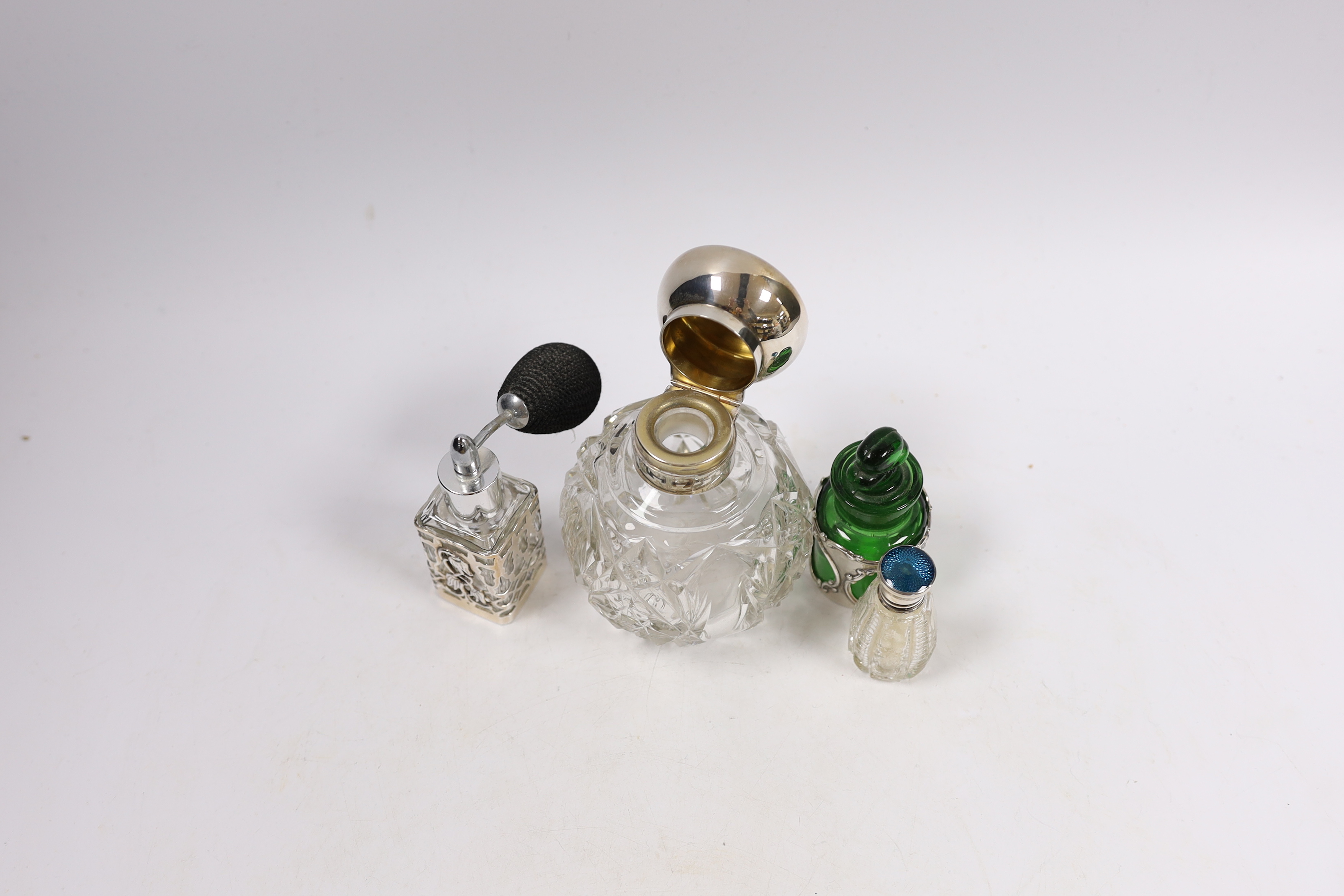 A George V silver mounted cut glass globular scent bottle, London, 1918, lacking stopper?, 11.2cm and three other silver mounted toilet jars.